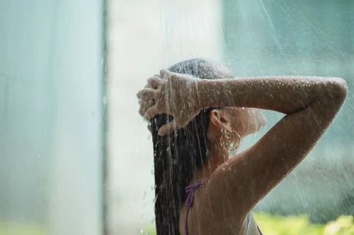Woman taking hot shower